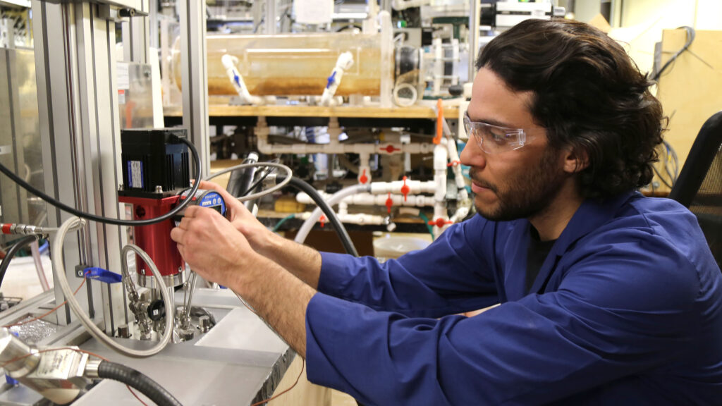 Man working on machinery in a lab-like setting