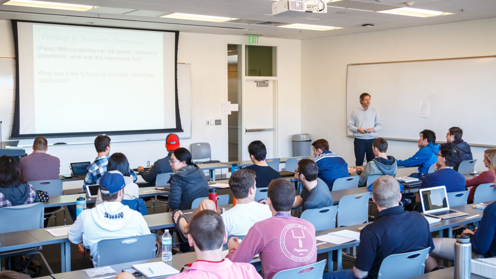 Professor teaching a class full of students on ethics