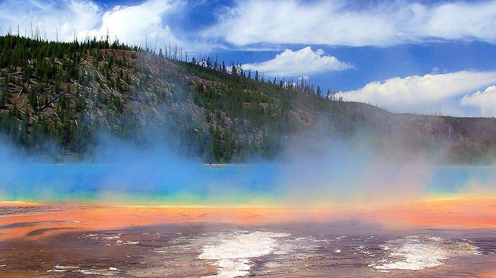 image of hot springs with mountains in the distance