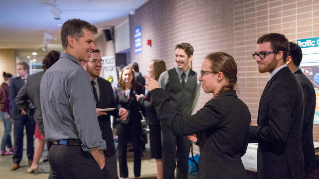 Students talking in a group during presentations