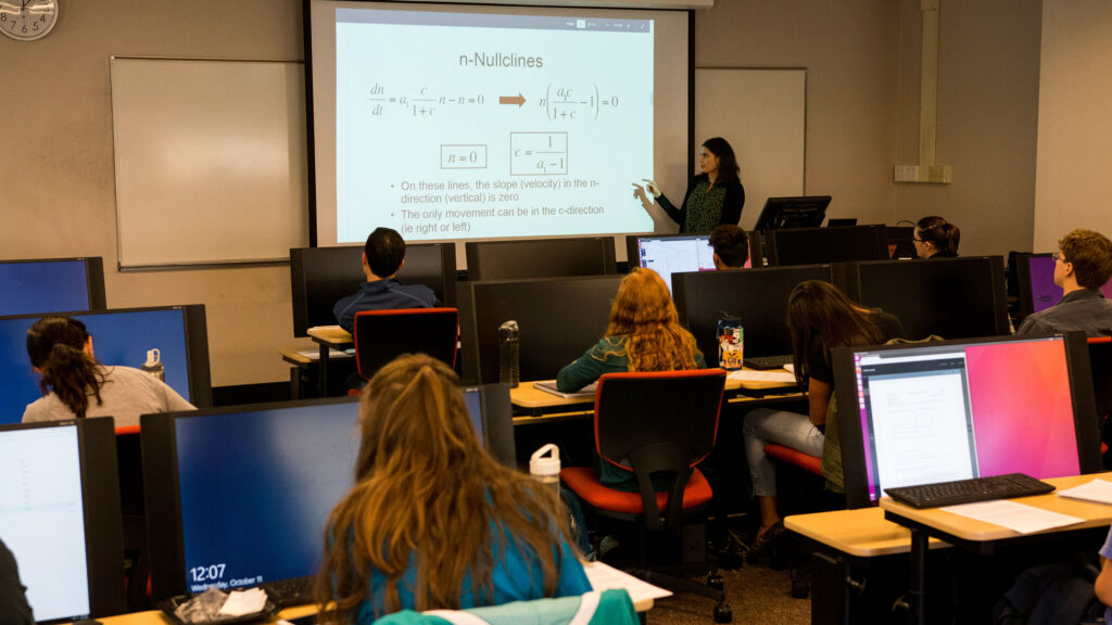 Professor teaching in classroom full of students