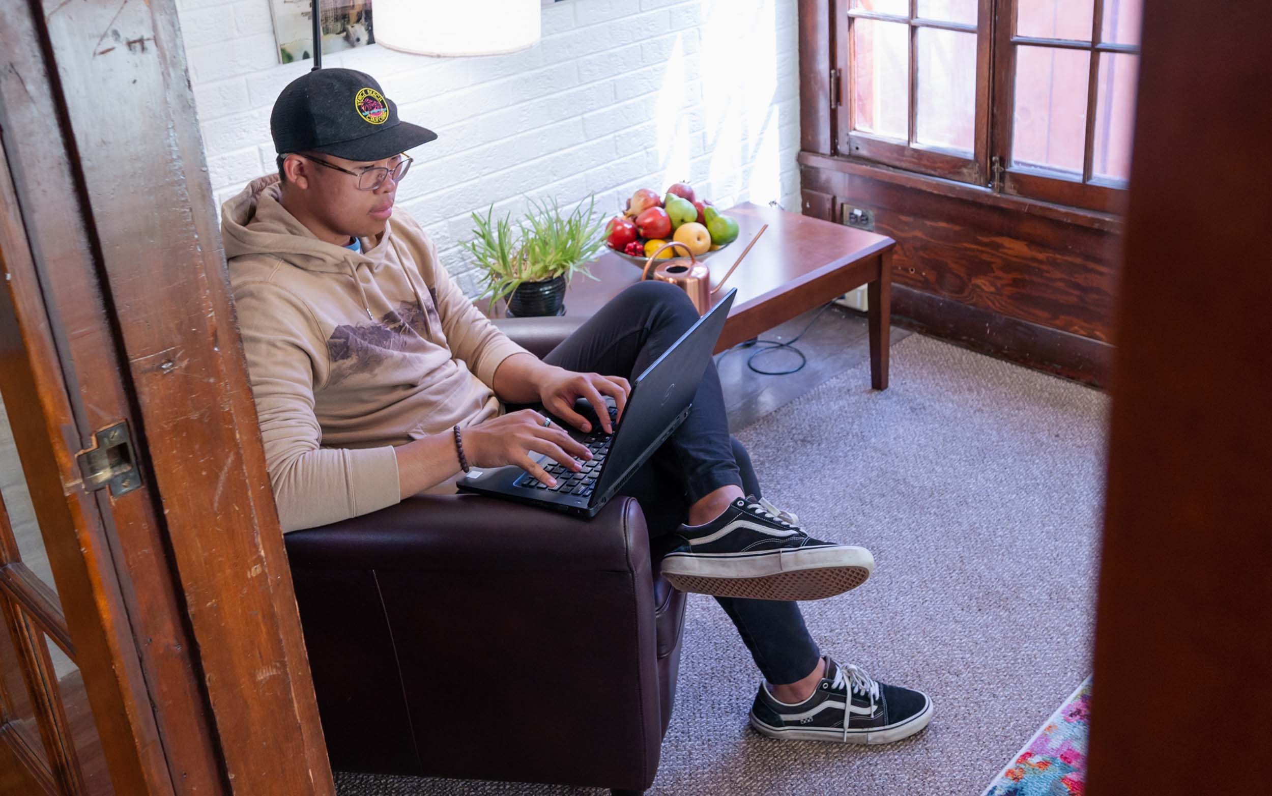 Student watching a video in their laptop in the Honors and Scholars house