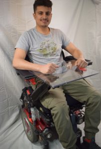 Team member Hamood seated in chair with final design
