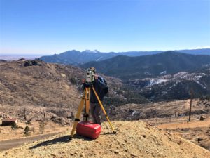 Patrick surveying atop a mine pile at Upper Sweet Home site