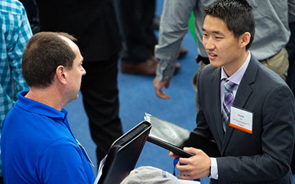 student and recruiter talking at career day