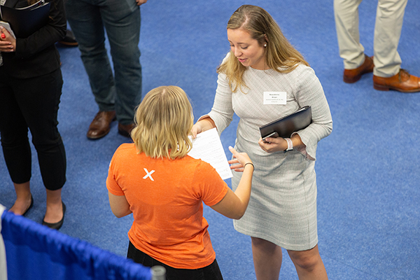 recruiter and student talking at career fair