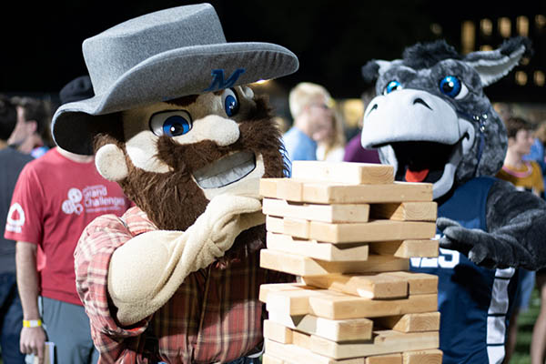 Marvin the Miner and Blaster mascots playing Jenga