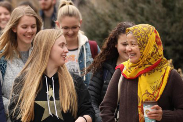 students and professor talking and walking