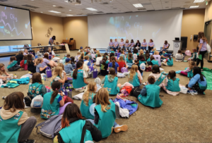 Girl scouts watching a presentation by SWE officers.
