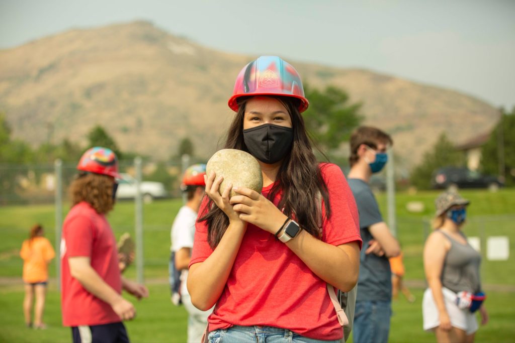 Female student holds rock at M Climb 2020