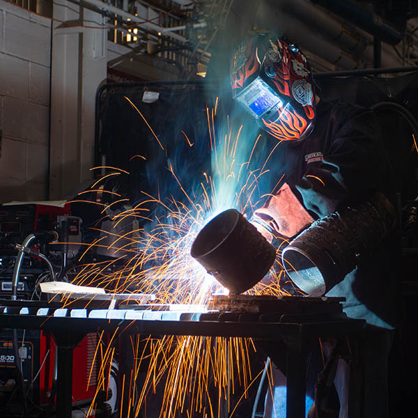 Student welding in lab