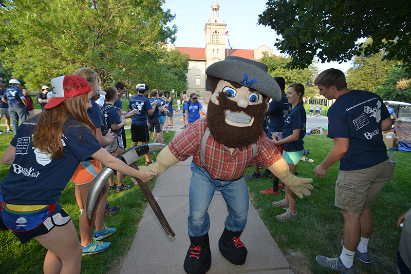 Marvin the Miner high-fiving Mines students