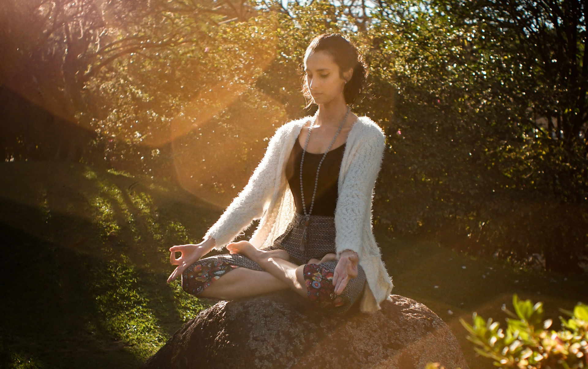 girl meditating on a rock