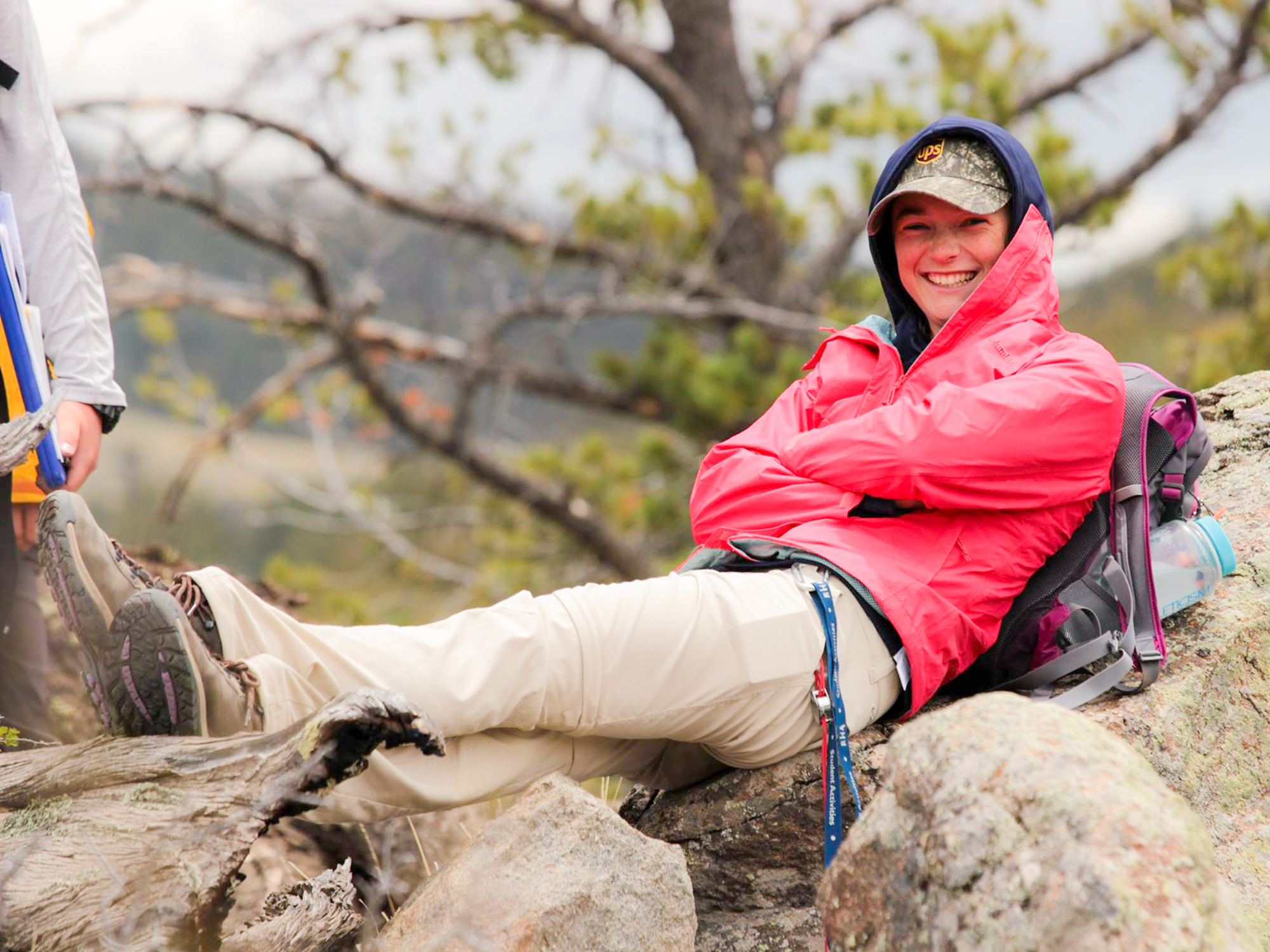 A Mines geology student sitting on rocks 