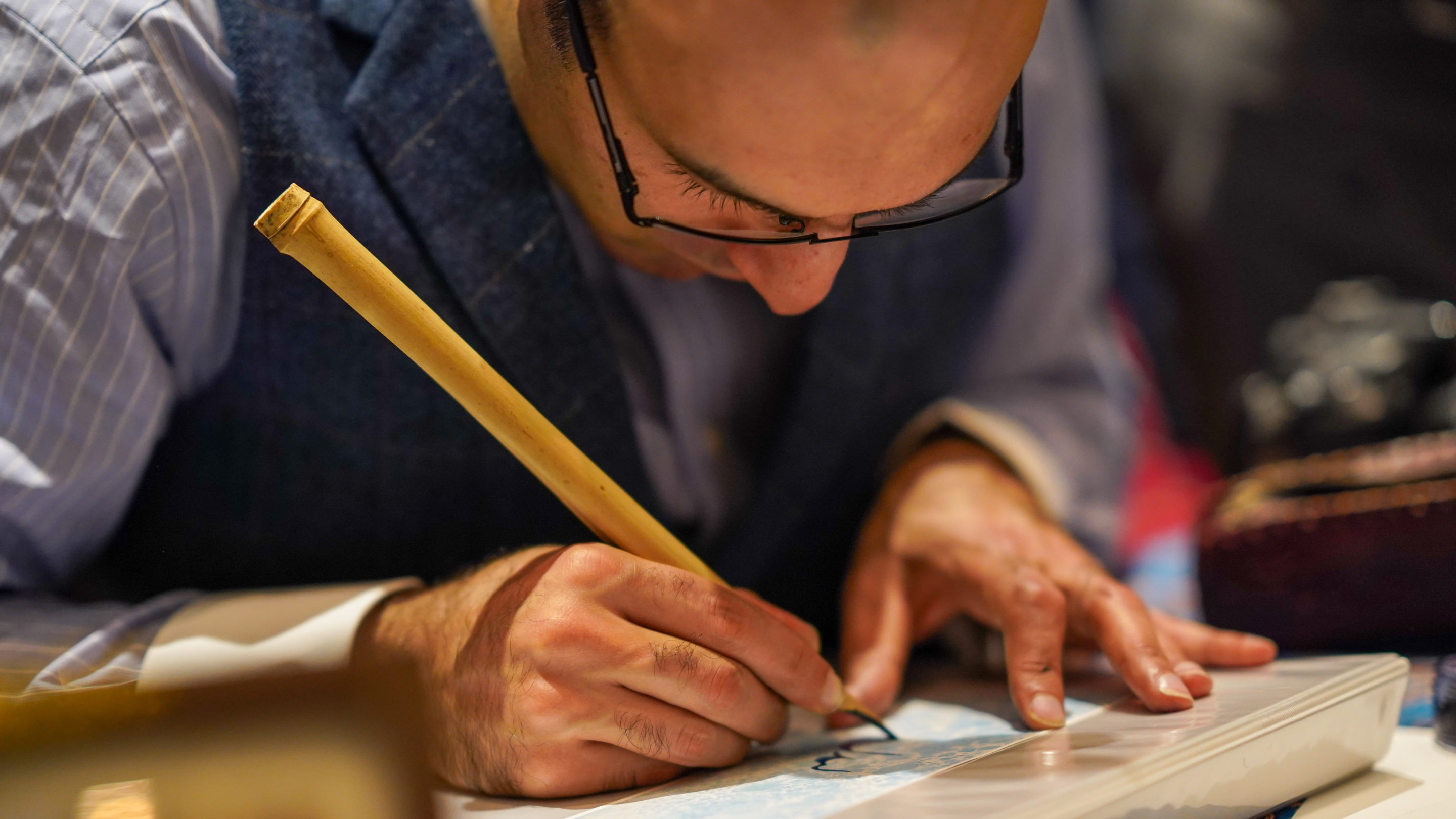 Navigates to the Accepted Students page. An image of a man writing.