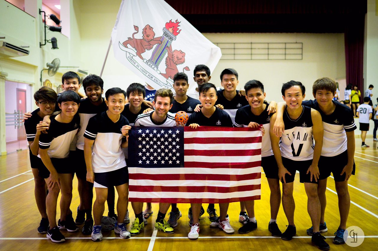 Photo Credit: Kevin Lynch 2017 Students standing behind an American flag on basketball court
