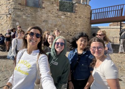 Students smiling on old brick structure in St. Tropez