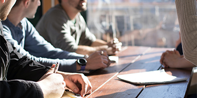 team meeting around wooden table