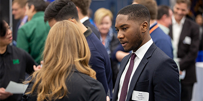 recruiter and student talking at career fair