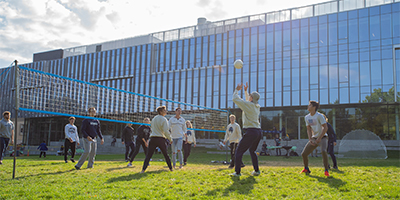 students playing volleyball outside