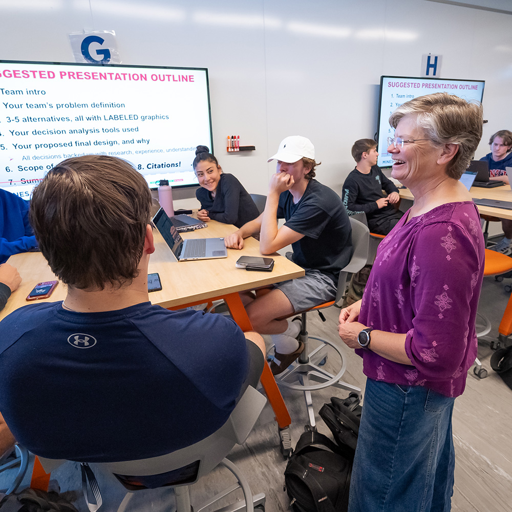 Professor teaching students in a research lab