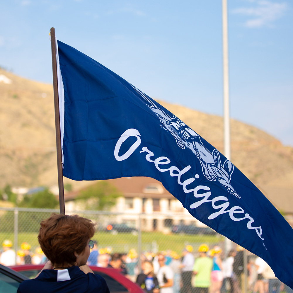 Colorado School of Mines employee holding and Oredigger flag