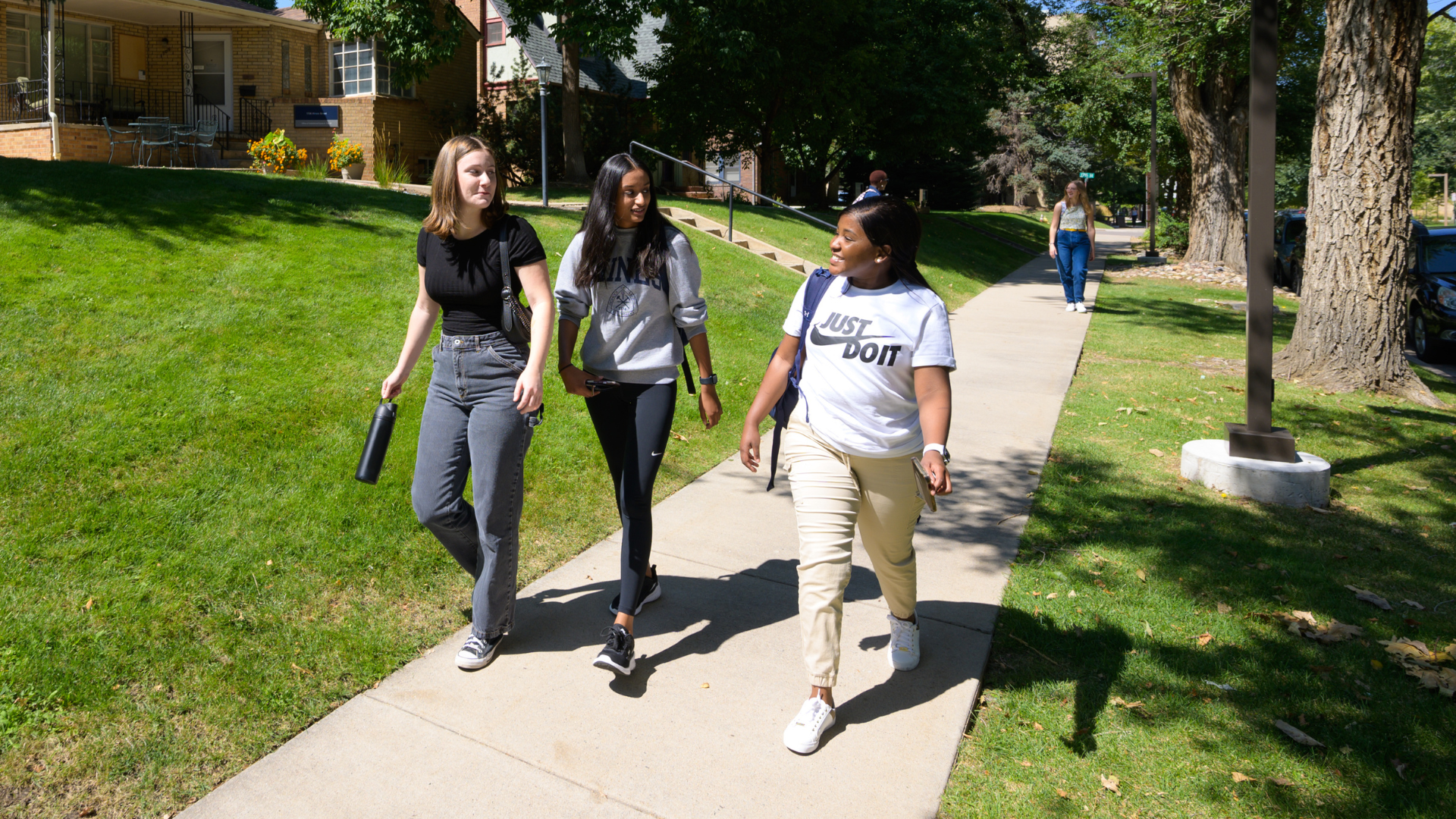 Students talk while walking down Illinois St on campus
