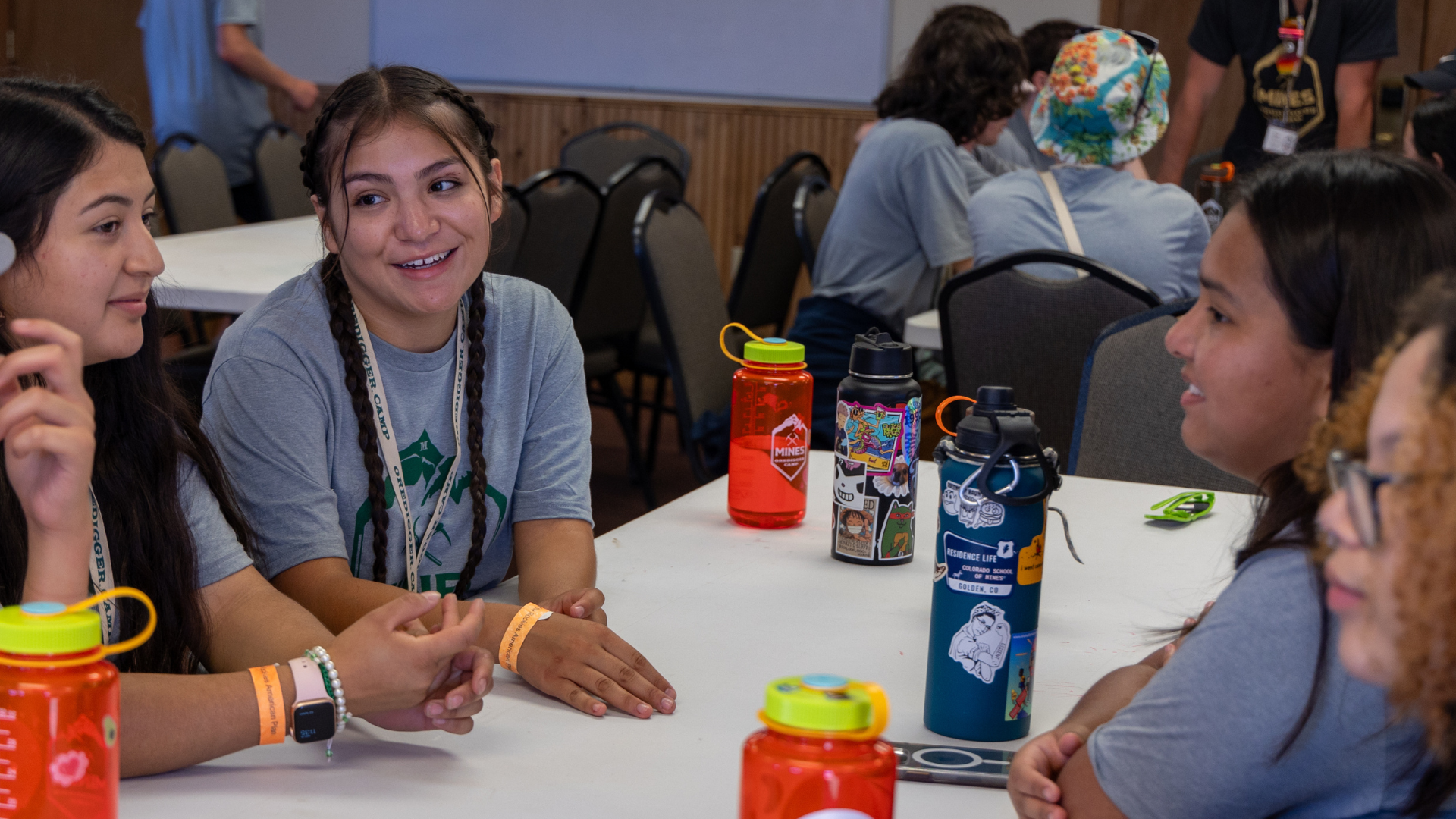 Students talk at a table during Oredigger Camp