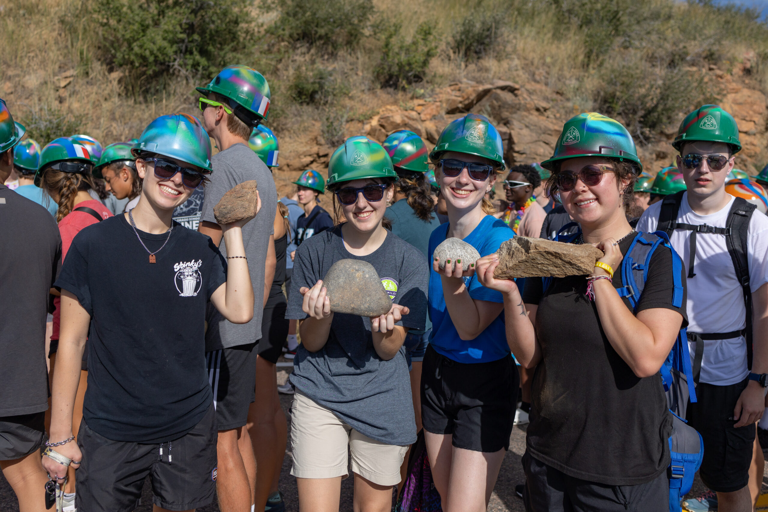 Students pose with their rocks during the M Climb