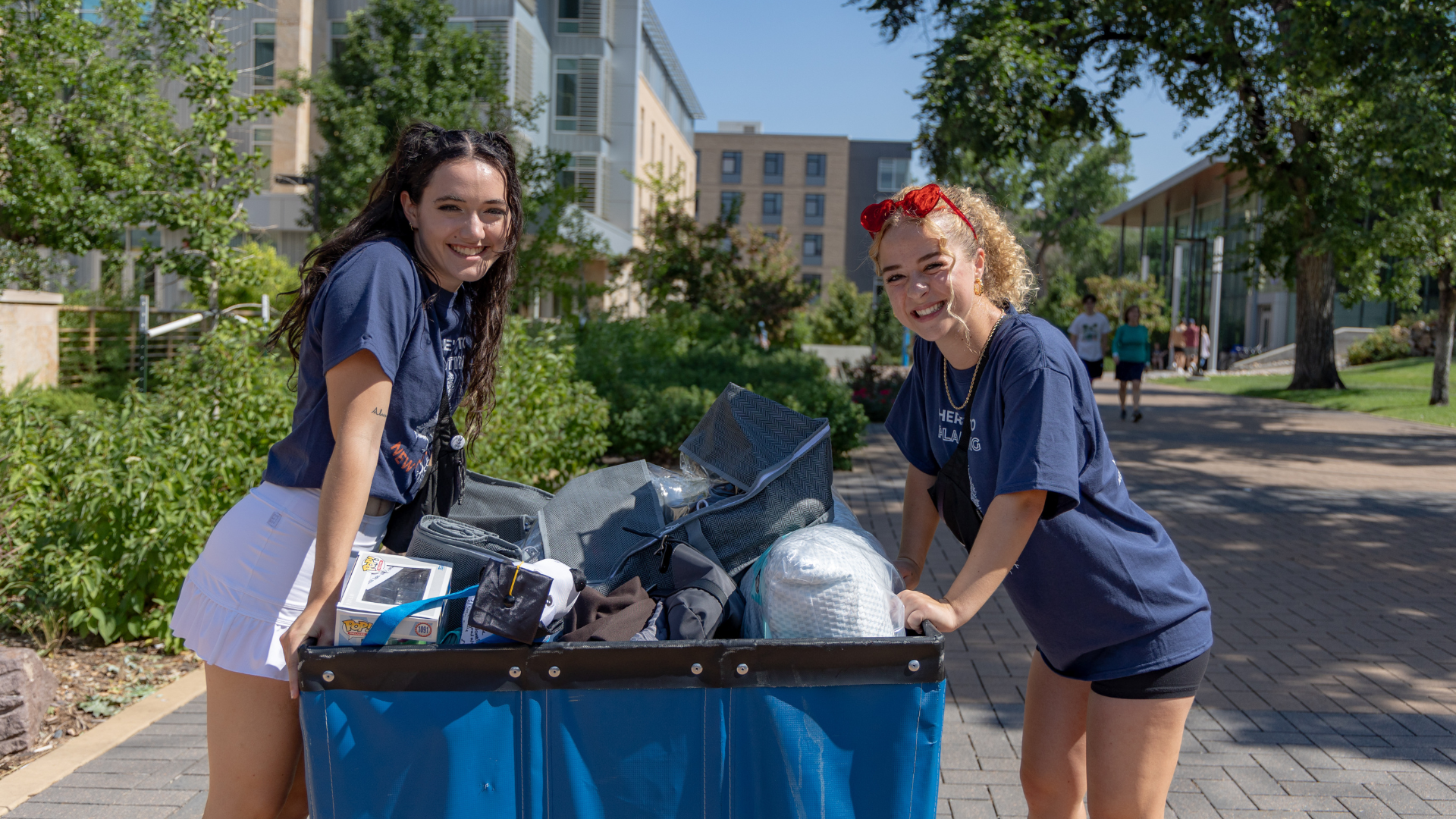 Two students pose while helping with first-year move in
