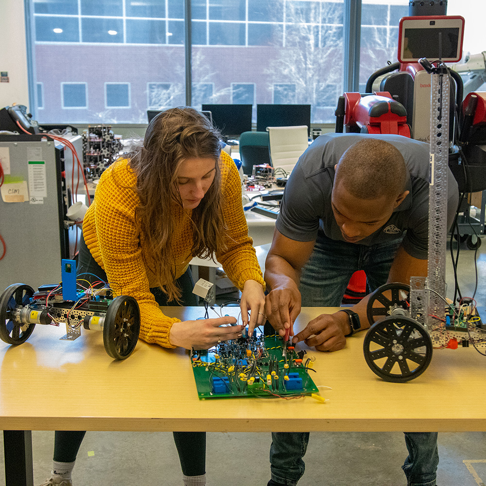 Electrical Engineering students working with circuits.