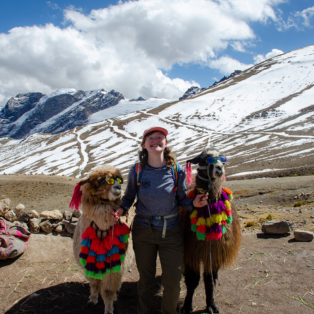 students posing with mountain in background