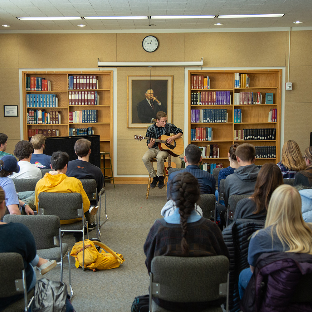 A student performing music in the library