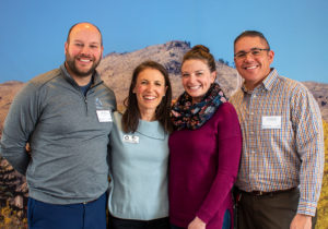 A picture of the PASCAL Center team in front of a background image of Mt. Zion.