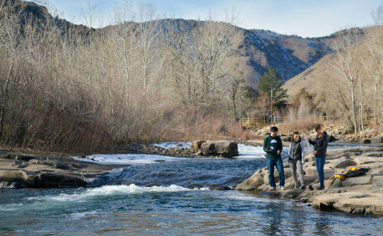 Postdoctoral researcher Jongeun You, PhD student Arielle Koshkin and Geology and Geological Engineering Assistant Professor Adrienne Marshall take measurements and test the water in Clear Creek.