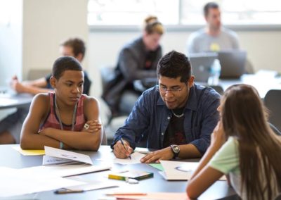 Students writing at a table