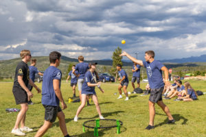 Oredigger Camp students playing smash ball outside a beautiful mountain landscape