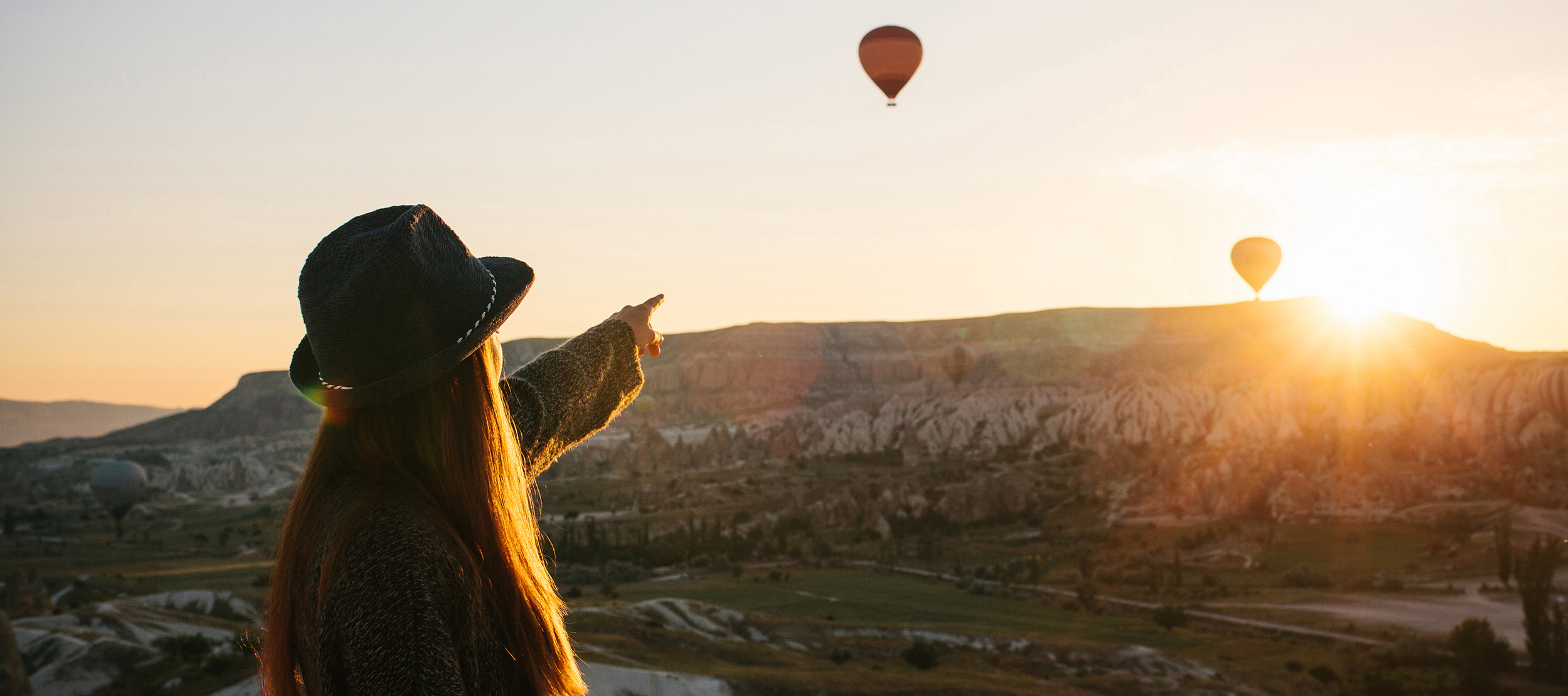 Girl pointing at the horizon