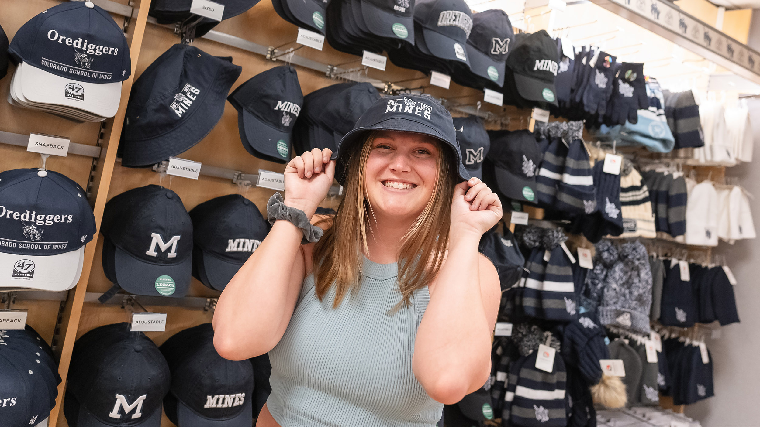 A photo of Olivia wearing a bucket hat in the bookstore.