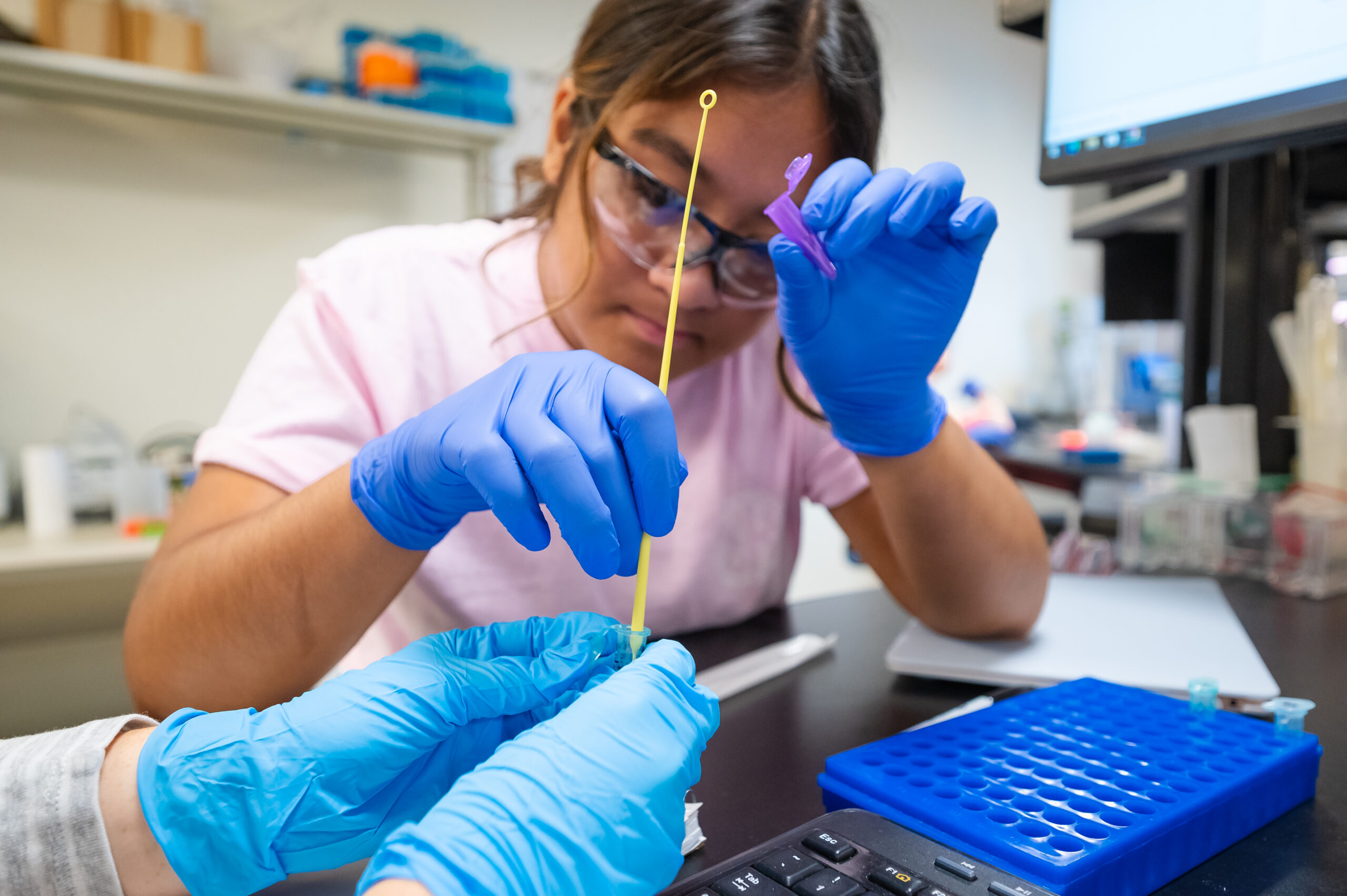 A student works in a bio lab.