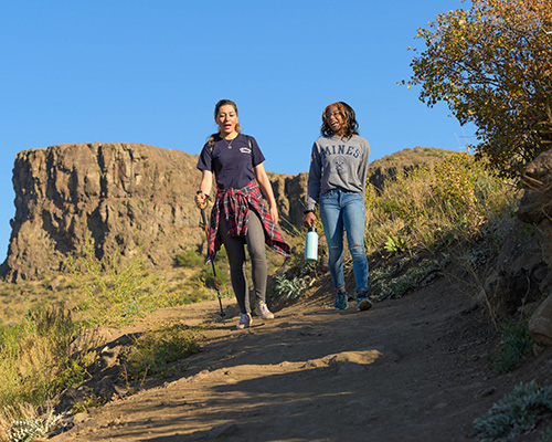 Two Mines students hiking on a trail near campus
