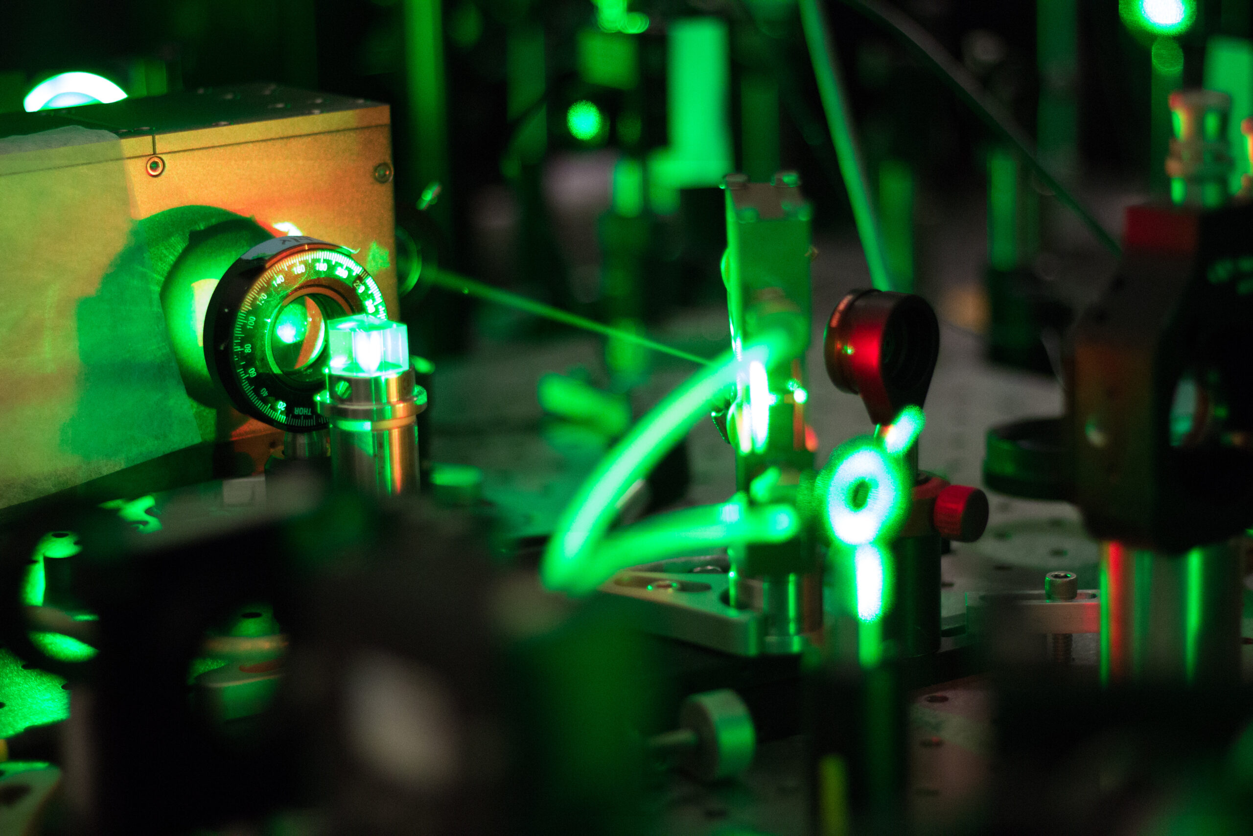 A laser comes out of a machine with devices to measure it surrounding the beam.