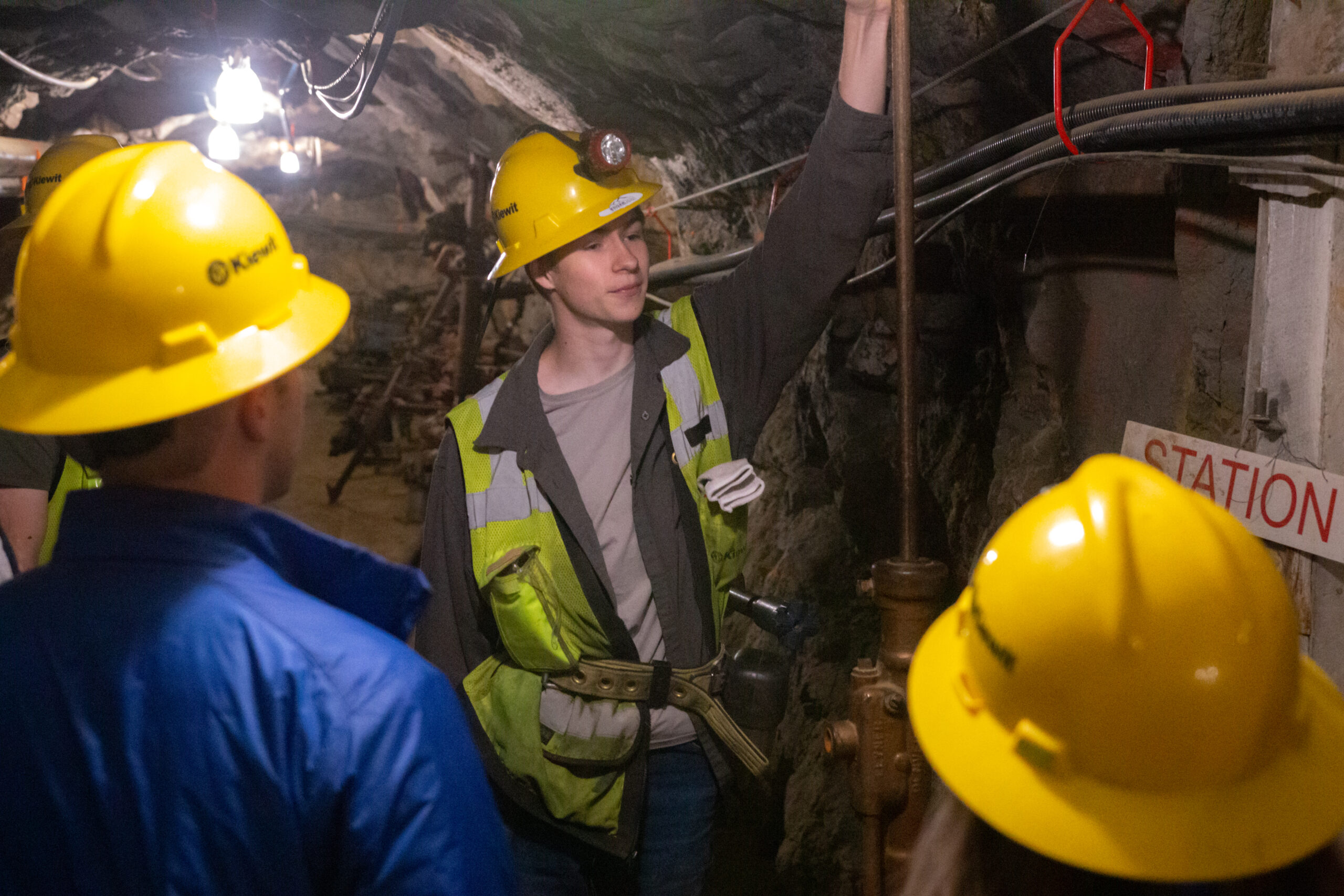 Students in a mine measuring height of ceiling. 