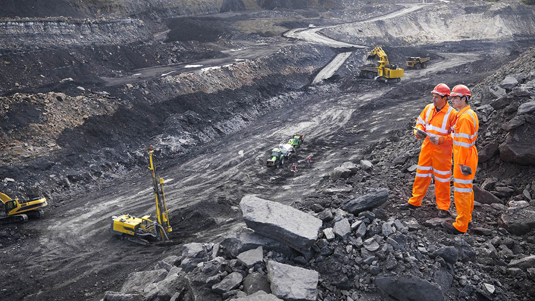 Mineral Exploration Workers Looking Over Coal Mine