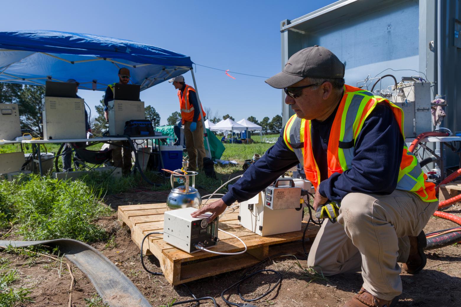 PFAS testing Jesse Rocha of Alliance Technical Group prepares to conduct air emission monitoring on several PFAS destruction technologies being tested side by side at Peterson Space Force Base during the summer of 2025. The Colorado School of Mines-led project was the first “apples to apples” assessment of destruction technologies conducted on PFAS-impacted sediment and researchers also gathered data on each technology's air emissions