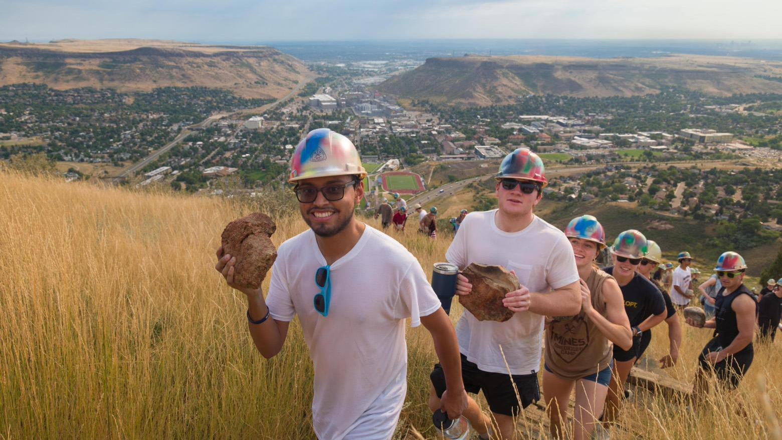 A line of new Mines undergraduates hike up Mt. Zion to participate in the tradition of placing a rock from their hometown on the M.